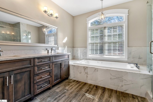 bathroom with vanity and independent shower and bath