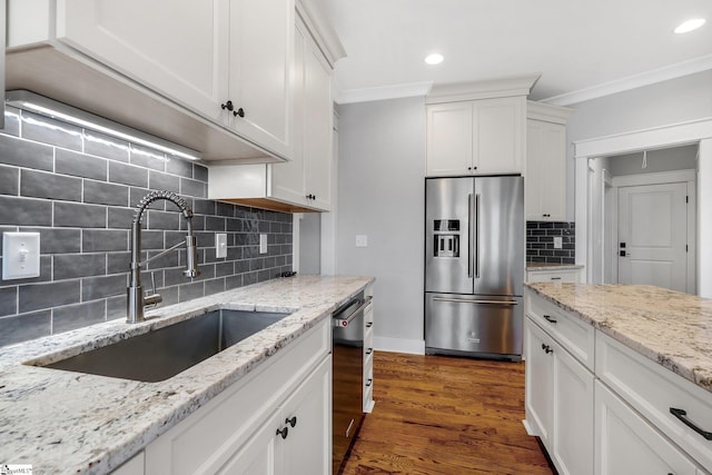 kitchen featuring white cabinets, stainless steel refrigerator with ice dispenser, black dishwasher, and sink