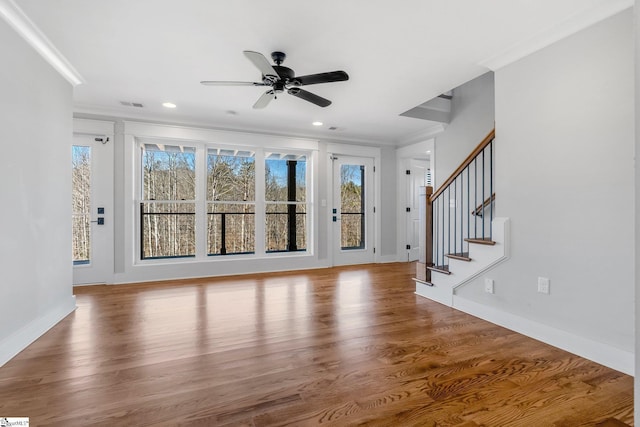 entryway featuring hardwood / wood-style flooring, ceiling fan, and ornamental molding