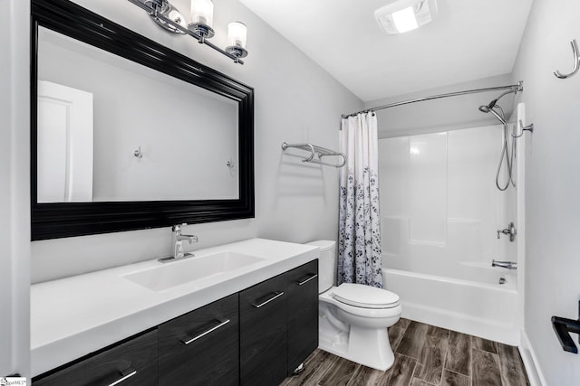 full bathroom featuring shower / bath combo, vanity, and toilet