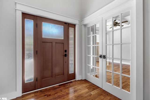 foyer entrance featuring ceiling fan, hardwood / wood-style floors, and french doors