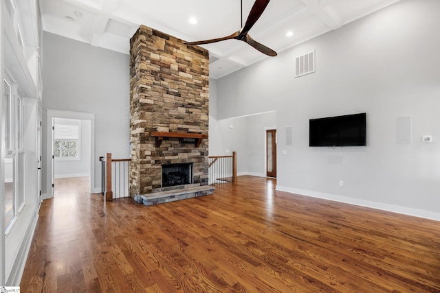 unfurnished living room with beamed ceiling, wood-type flooring, and coffered ceiling