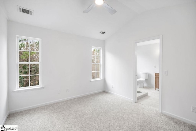 spare room with light carpet, ceiling fan, and lofted ceiling