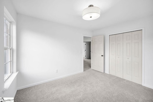 unfurnished bedroom featuring a closet and carpet