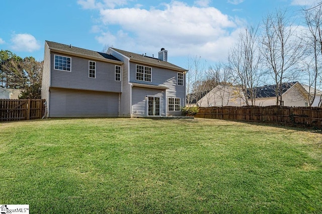 back of house with a lawn