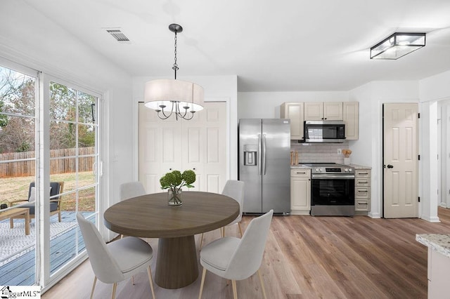 dining space featuring a notable chandelier and wood-type flooring