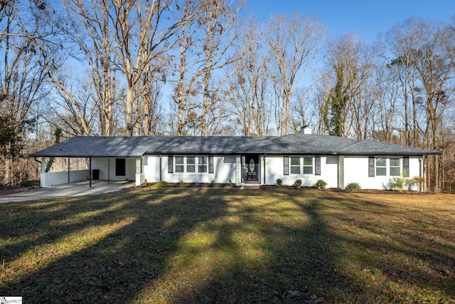 single story home featuring a front lawn and a carport