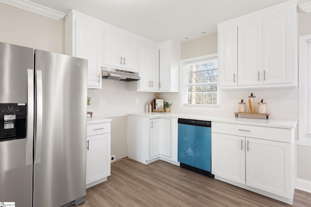 kitchen with light wood-type flooring, stainless steel appliances, and white cabinetry