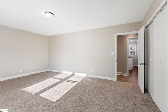 unfurnished bedroom featuring carpet and a closet