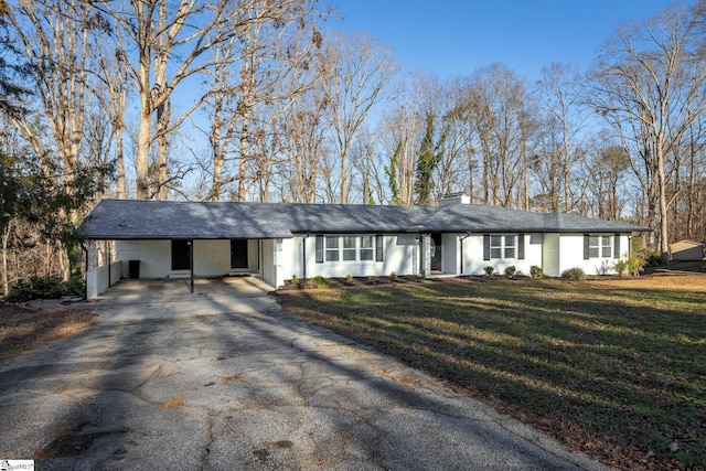 ranch-style home with a front lawn and a carport