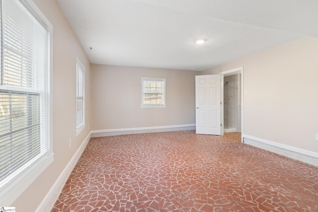 unfurnished room featuring a textured ceiling