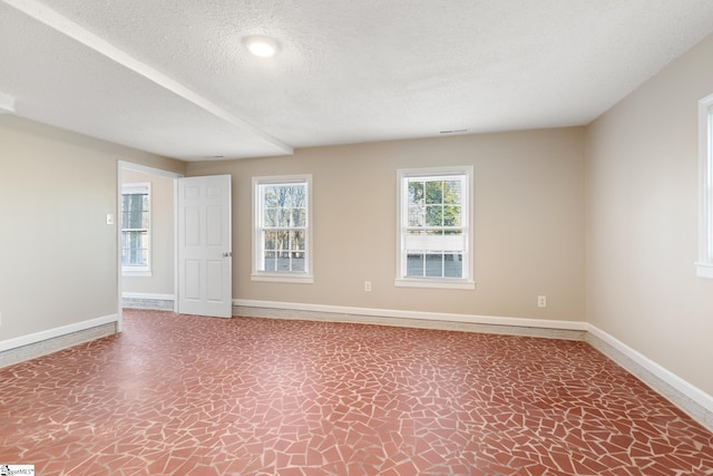 spare room featuring a textured ceiling