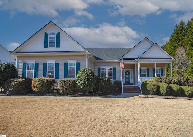 view of front of home featuring covered porch and a front yard