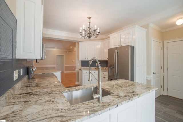 kitchen featuring dark wood-type flooring, white cabinets, sink, decorative backsplash, and stainless steel appliances