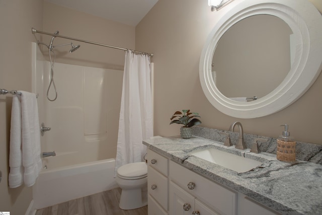 full bathroom featuring hardwood / wood-style flooring, vanity, toilet, and shower / tub combo with curtain