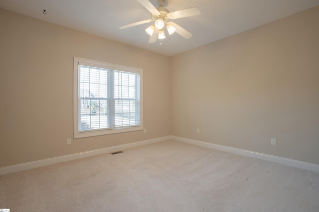 unfurnished room with light carpet and ceiling fan