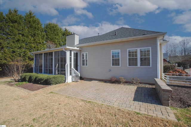 back of property with a patio area and a sunroom