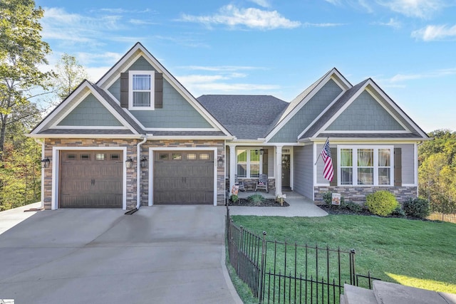 craftsman-style home featuring a porch, a garage, and a front lawn