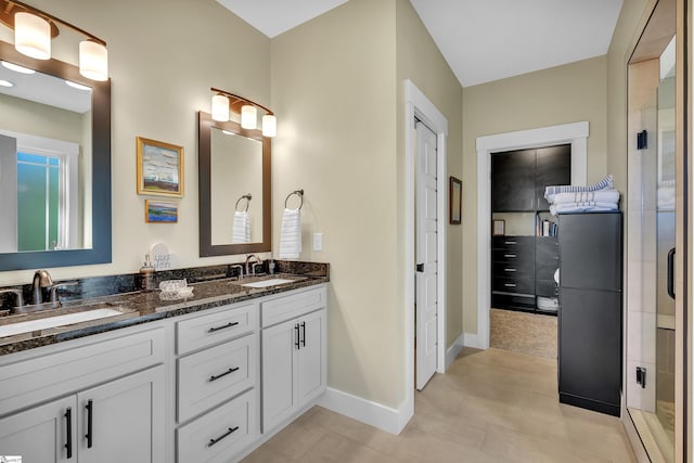 bathroom with tile patterned floors, vanity, and an enclosed shower