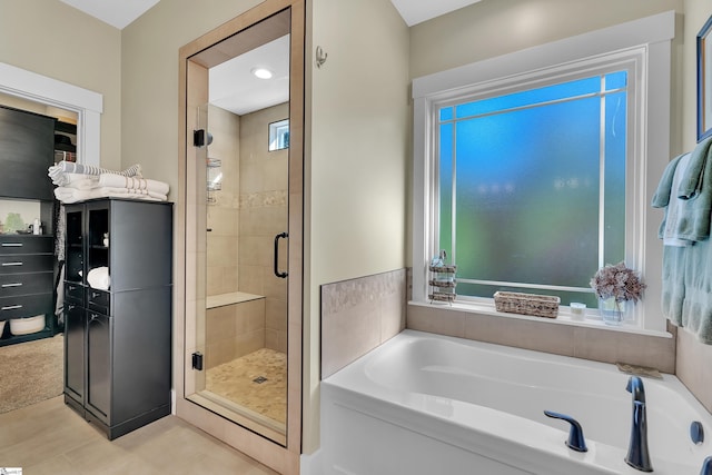 bathroom with tile patterned flooring and independent shower and bath