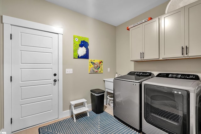 laundry area with cabinets and separate washer and dryer