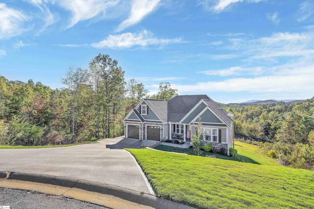 view of front of house featuring a garage and a front lawn