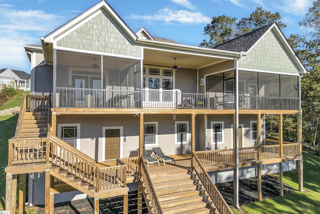 back of property with ceiling fan and a sunroom