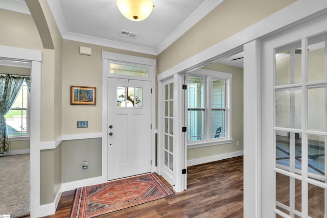 entryway featuring crown molding, dark hardwood / wood-style flooring, and a textured ceiling