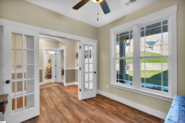 empty room with hardwood / wood-style flooring, ceiling fan, and french doors