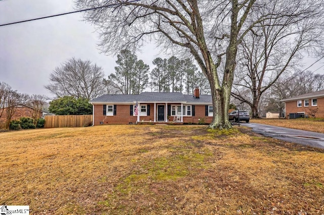 ranch-style house with a porch and a front lawn