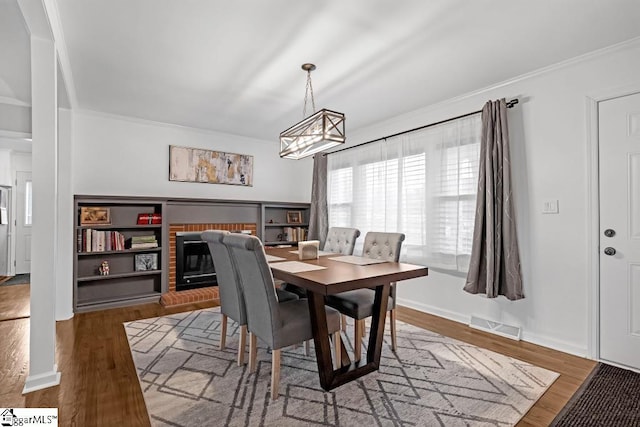 dining space with dark hardwood / wood-style flooring and ornamental molding