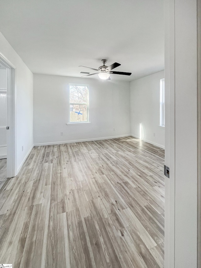 spare room with light hardwood / wood-style flooring and ceiling fan