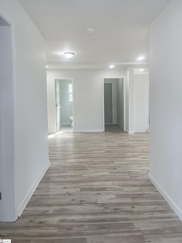 hallway with light hardwood / wood-style flooring