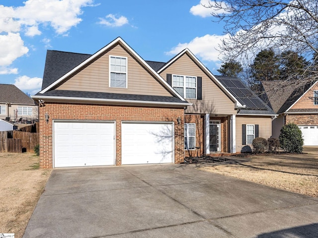 view of front of home featuring solar panels and a garage