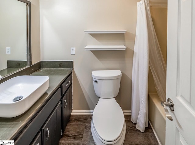 bathroom with hardwood / wood-style flooring, vanity, and toilet