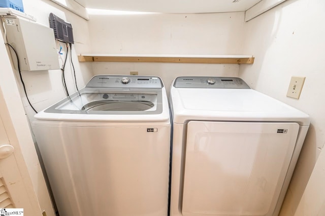 clothes washing area with washer and clothes dryer