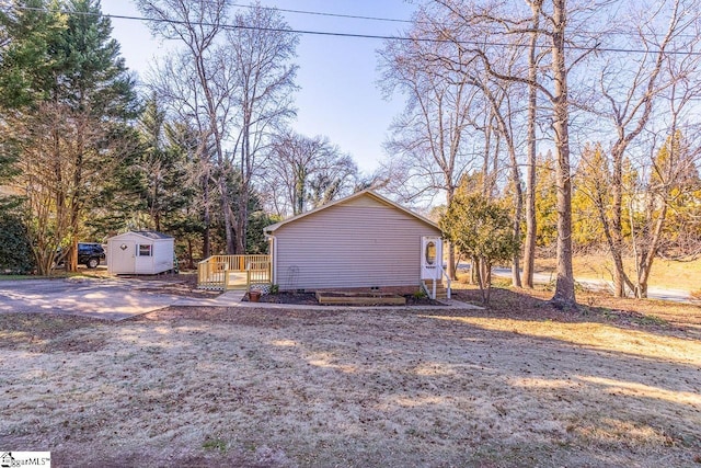 view of side of property featuring a shed and a deck