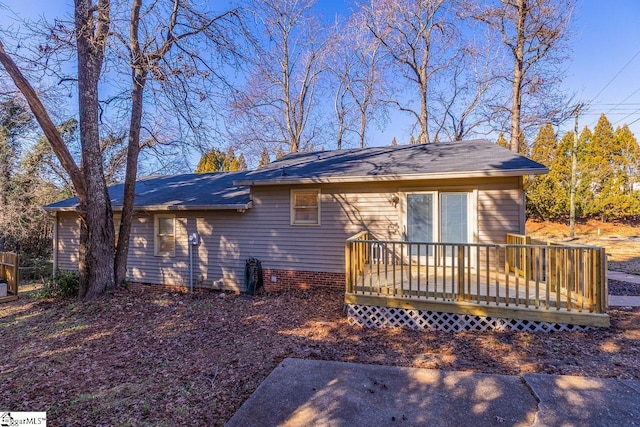 rear view of property featuring a wooden deck