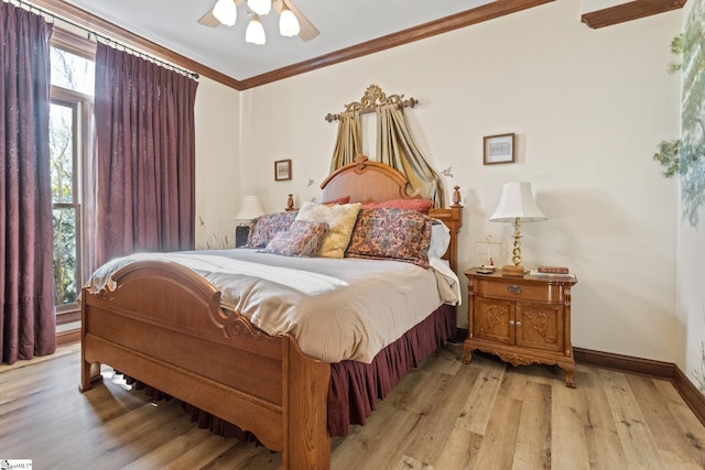 bedroom featuring ceiling fan, light hardwood / wood-style floors, and ornamental molding