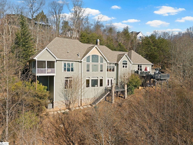 rear view of house featuring a sunroom