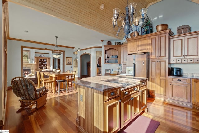 kitchen featuring a center island, ornamental molding, decorative light fixtures, stainless steel fridge with ice dispenser, and wood ceiling