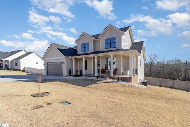 modern farmhouse style home with cooling unit, a porch, and a garage