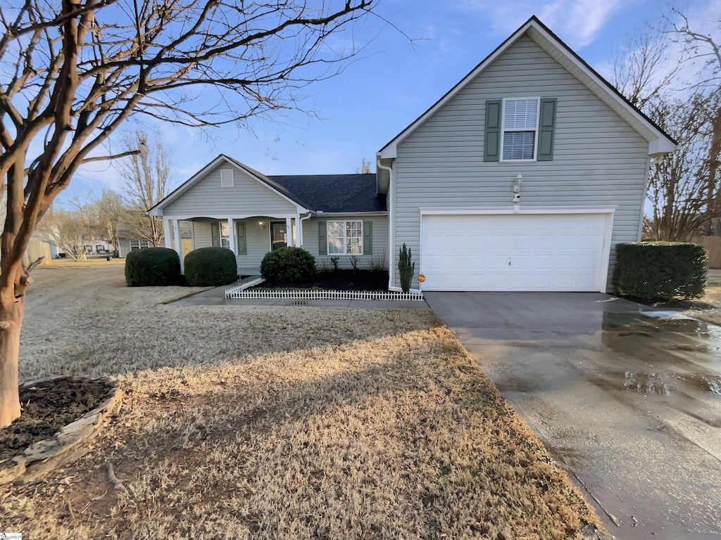 view of front property featuring covered porch and a garage
