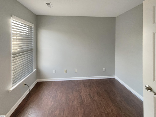 spare room with dark hardwood / wood-style flooring