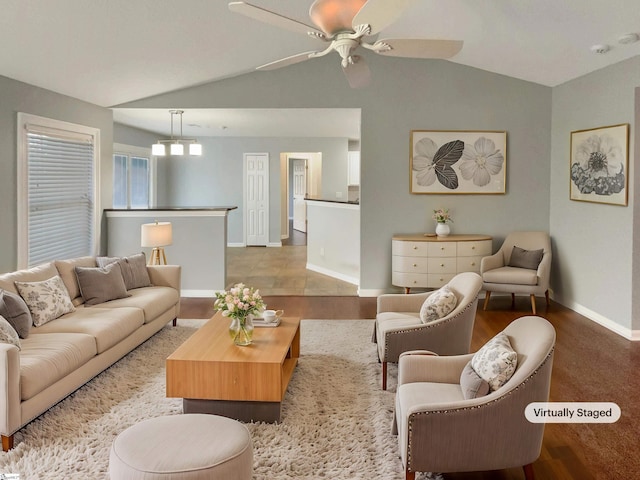 living room featuring ceiling fan and vaulted ceiling