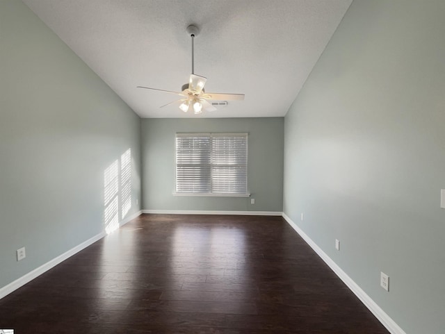 spare room with ceiling fan and dark hardwood / wood-style flooring