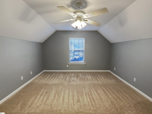 additional living space with ceiling fan, carpet floors, and vaulted ceiling