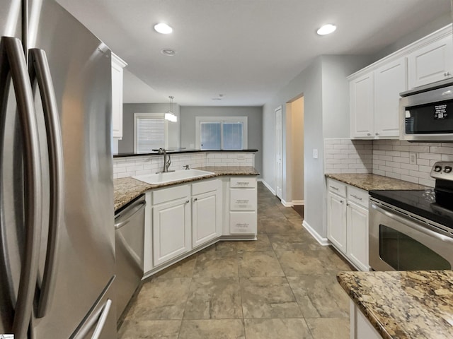 kitchen featuring sink, white cabinetry, stainless steel appliances, and stone counters