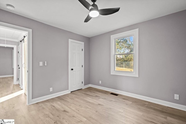 unfurnished bedroom with ceiling fan and light hardwood / wood-style flooring