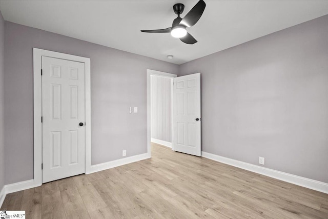 unfurnished bedroom with ceiling fan and light wood-type flooring